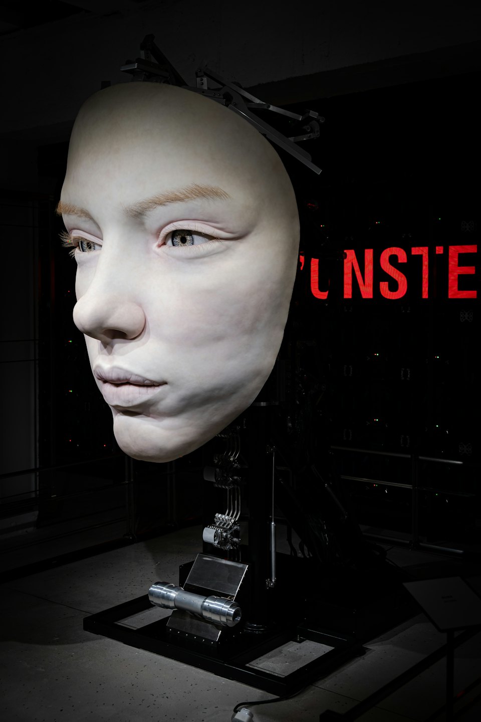 Profile view of a humanoid robot head with mechanical neck components.