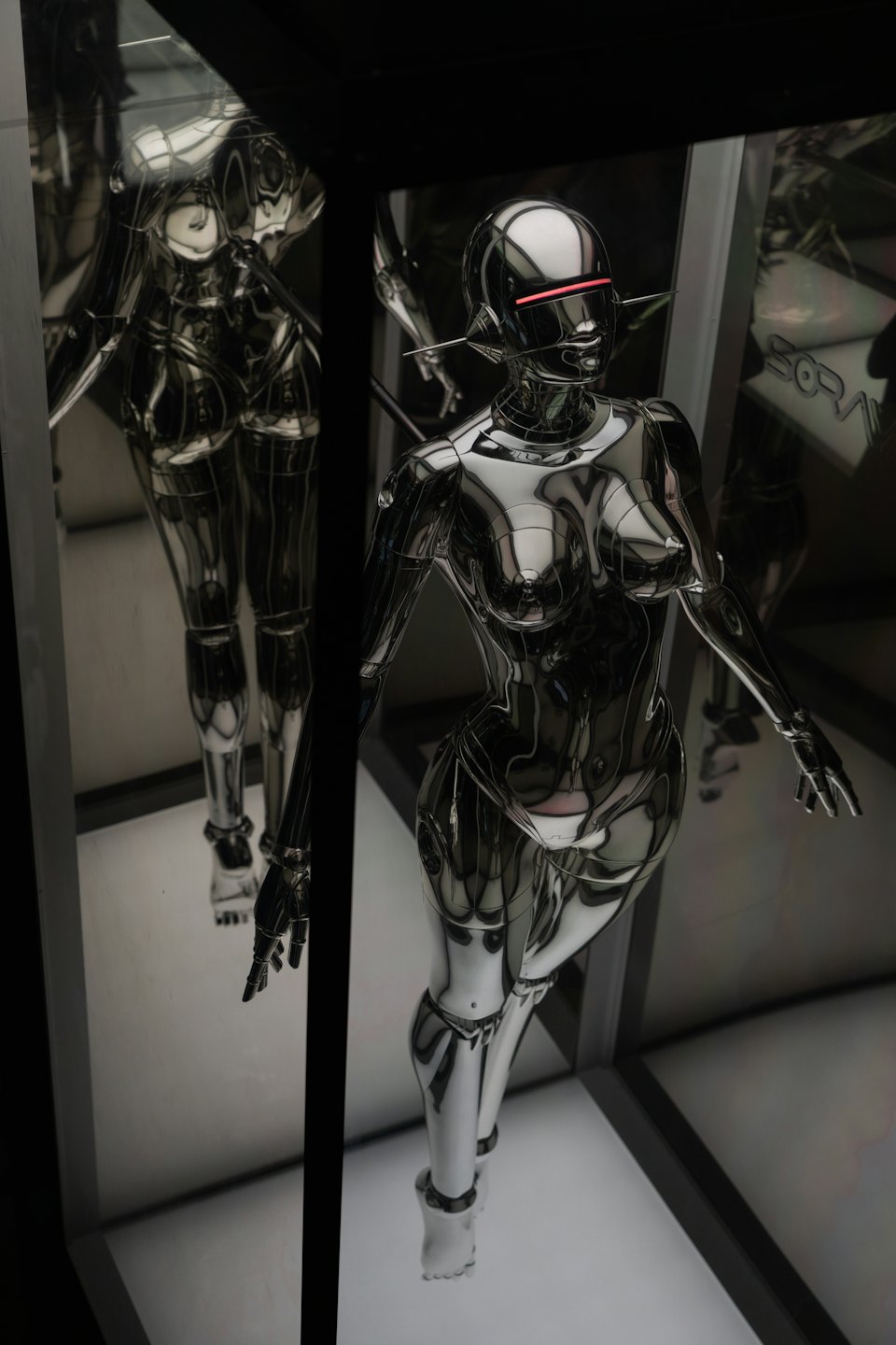 Chrome robot stands in a high-tech display.
